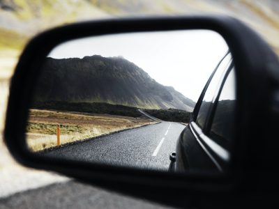 black wing mirror showing road