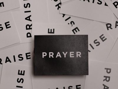 a pile of black and white paper with the word prayer on it