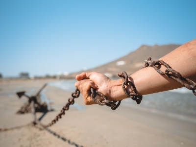 a person holding a chain on a beach